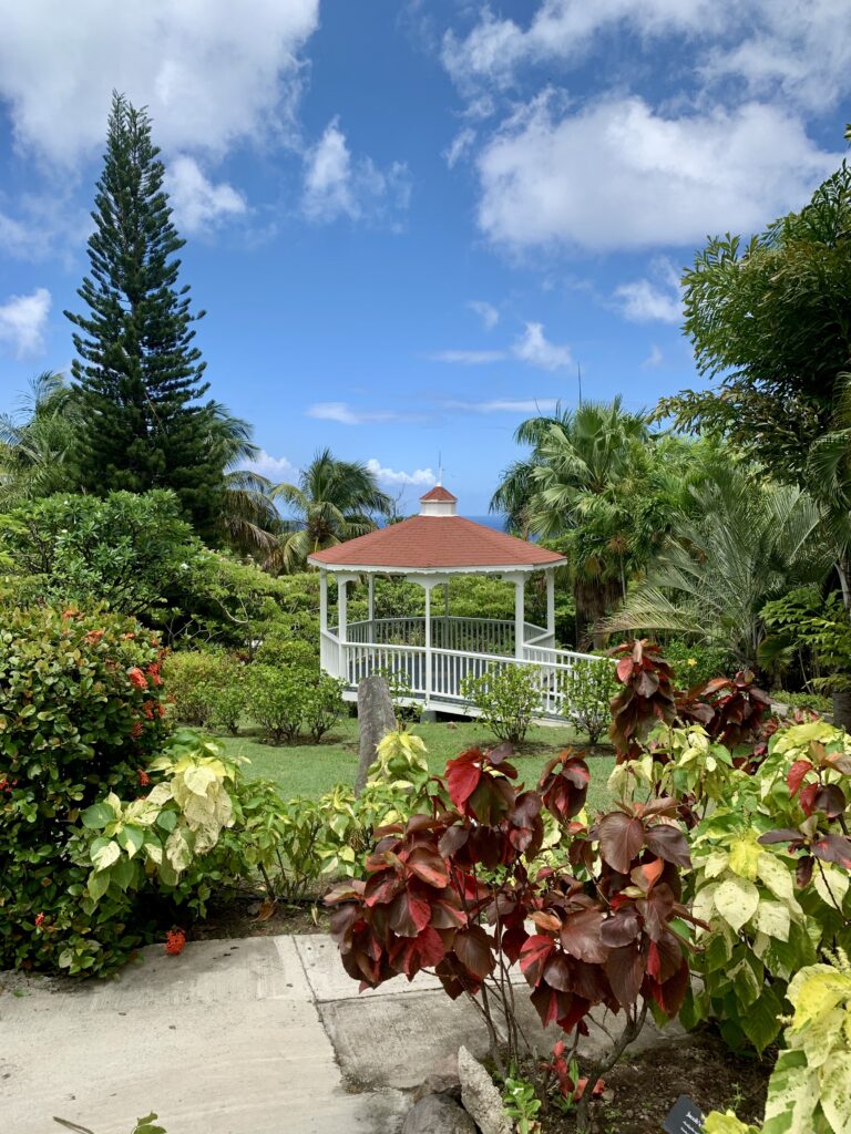 Sunny view of a a gazebo set in a lush garden