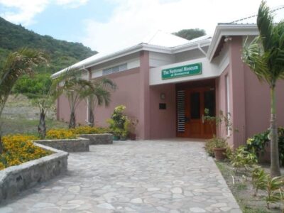 Angled view of the pink National Museum of Montserrat Entry