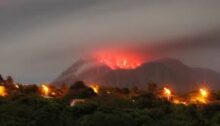 Night shot of fiery lava streaking out of the Soufriere Hills Volcano