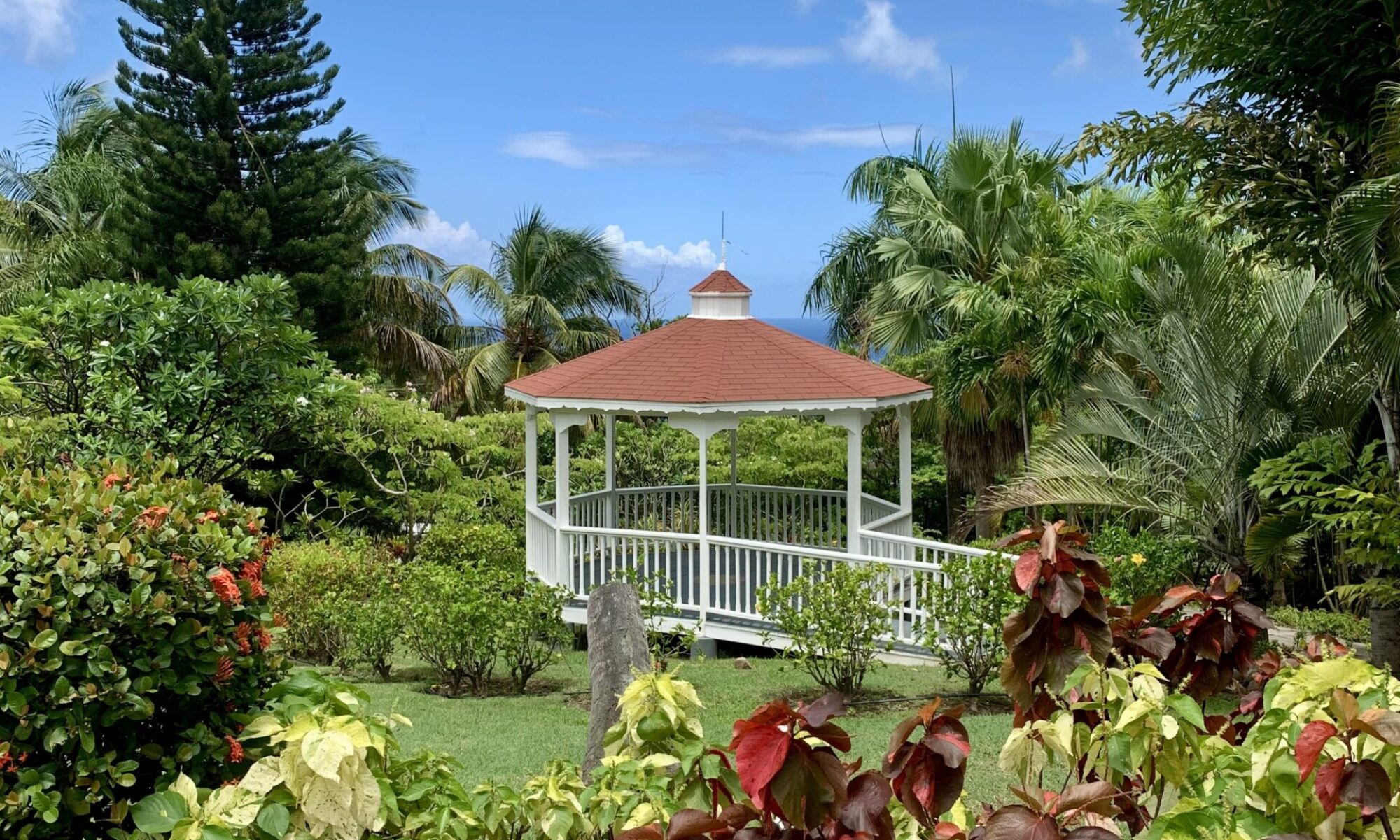 Sunny view of a a gazebo set in a lush garden